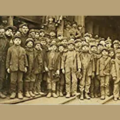 Historic photo of a large group of child laborers standing outside a factory.