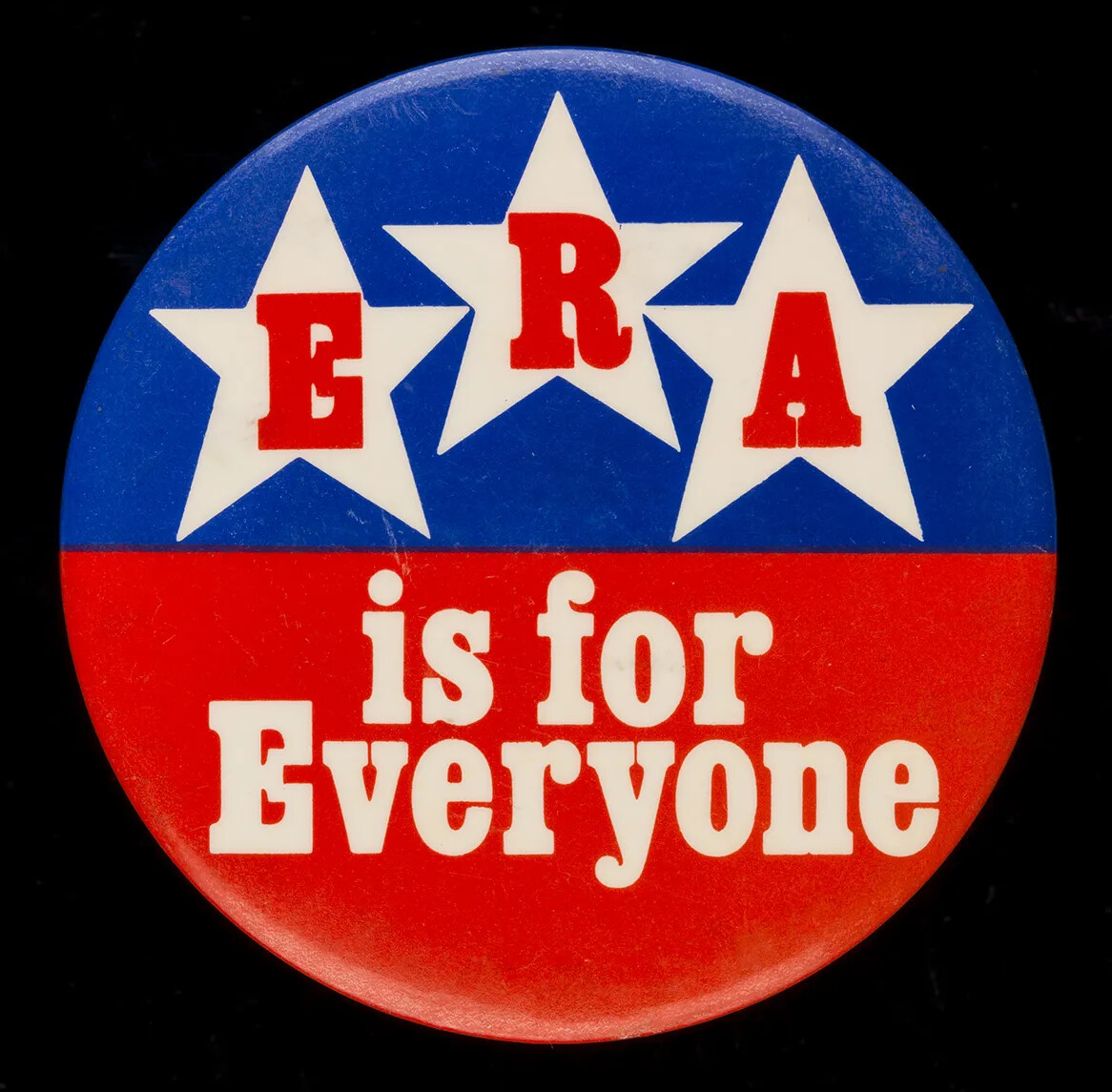 A circular red and blue button. On the blue half of the button are three white stars and the letters "E," "R," and "A" in red text in each of the stars. On the red half of the button are the words "is for/Everyone" in white text.