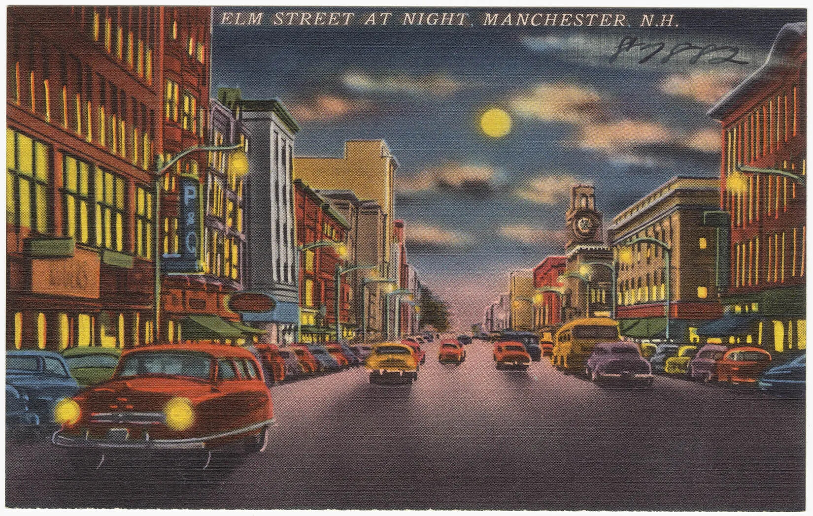 A colored postcard of a wide street bordered by multi-storied buildings. Multi-colored cars can be seen traveling down both sides of the street. The title of the postcard, located along the upper border, reads "ELM STREET AT NIGHT, MANCHESTER, N.H."