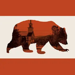 Silhouette of a bear filled with a scenic image of a small-town street featuring a church with a steeple, trees, and a distant hillside.
